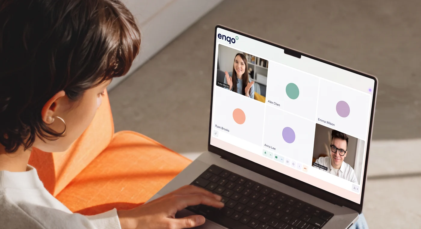 A person on an Enqo video call with colleagues on a laptop